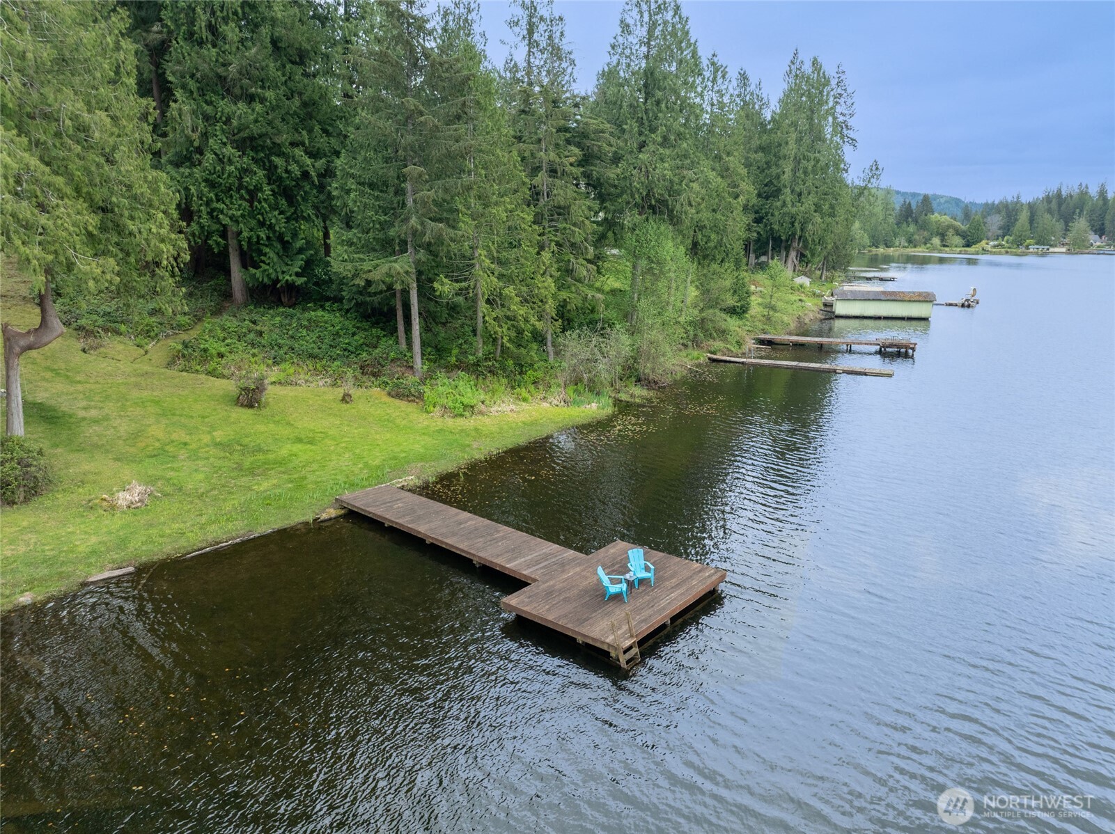 1028 South Lake Roesiger Road Snohomish, WA 98290 - Photo 17 of 38 a view of a lake with a yard and trees