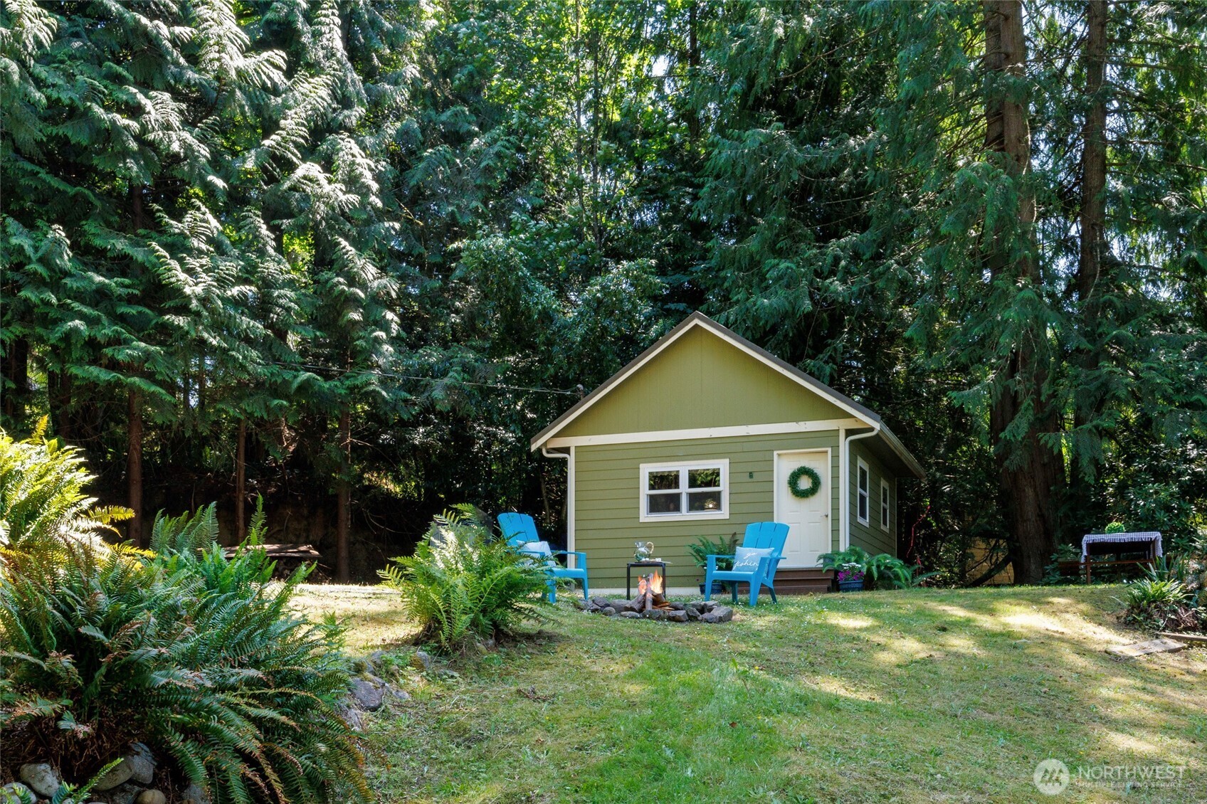 1028 South Lake Roesiger Road Snohomish, WA 98290 - Photo 22 of 38 a front view of a house with a yard and trees