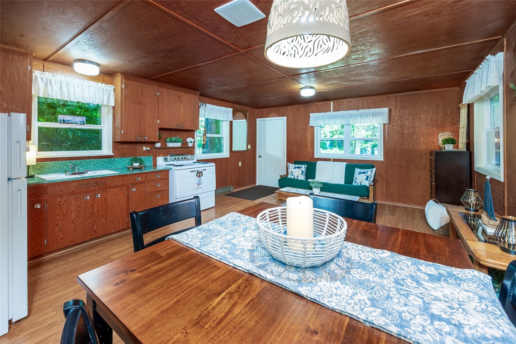 1028 South Lake Roesiger Road Snohomish, WA 98290 - Photo 32 of 38 a kitchen with a stove a table and chairs in it