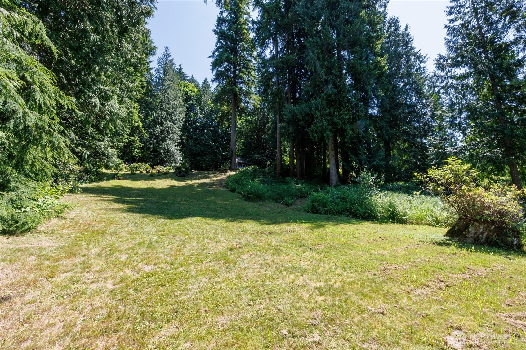 1028 South Lake Roesiger Road Snohomish, WA 98290 - Photo 34 of 38 a view of a garden with a bench
