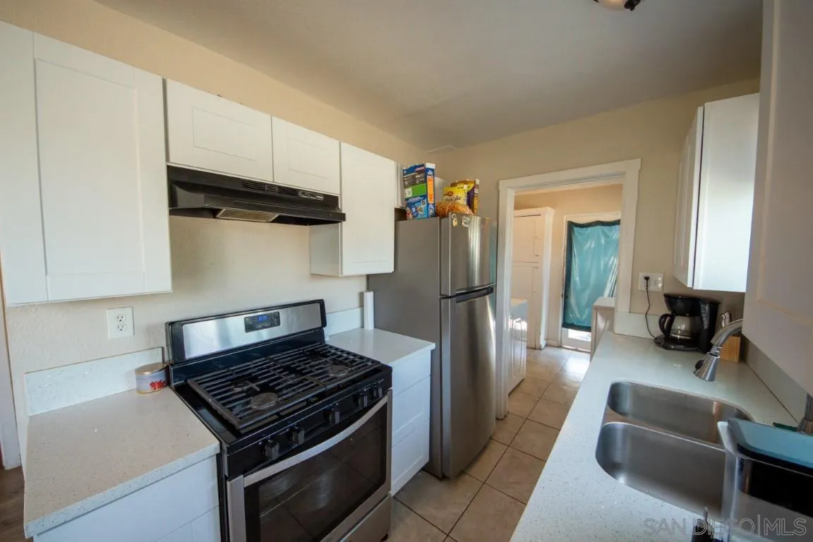 6159 Nogales Street Riverside, CA 92506 - Photo 5 of 14 a kitchen with stainless steel appliances granite countertop a refrigerator and a stove top oven