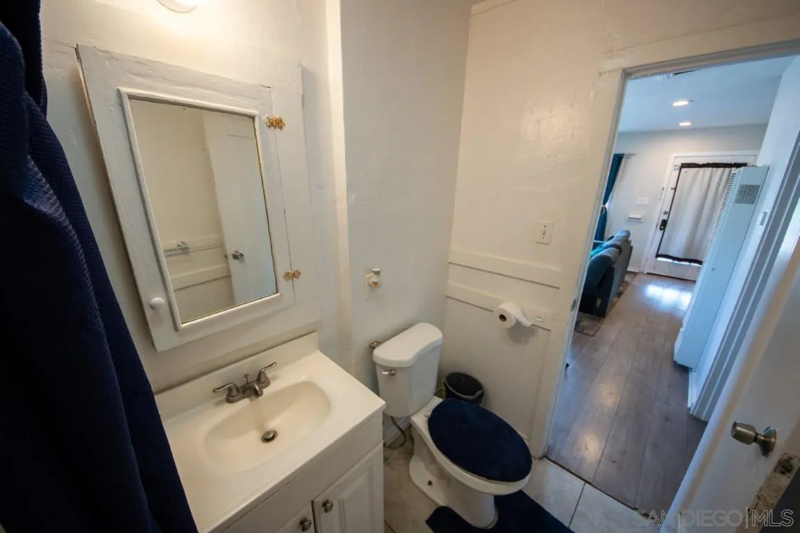 6159 Nogales Street Riverside, CA 92506 - Photo 6 of 14 a bathroom with a sink and mirror with toilet