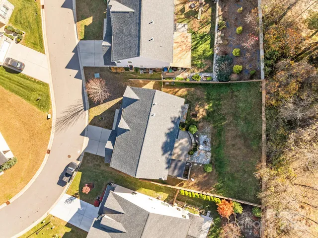 an aerial view of a house with swimming pool outdoor seating