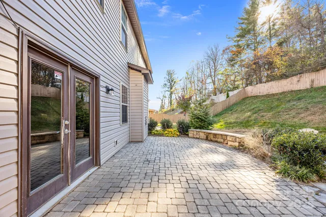 a view of a brick house with a yard
