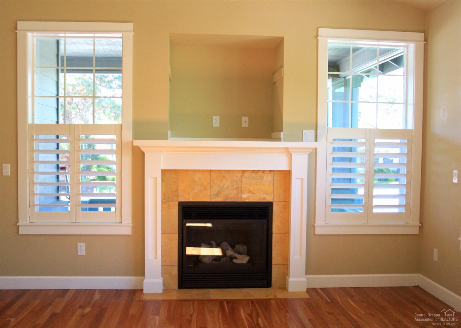 19459 Blue Lake Loop Bend, OR 97702 - Photo 5 of 19 a living room with a fireplace and a window