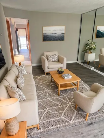 a living room with furniture and a potted plant