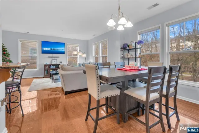 a view of a dining room with furniture wooden floor and chandelier