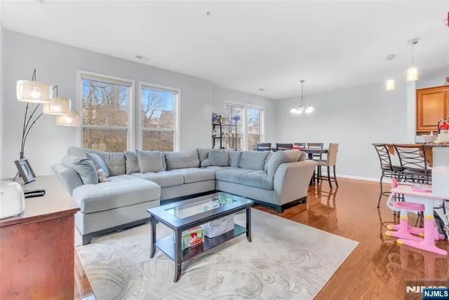 a living room with furniture a large window and a table