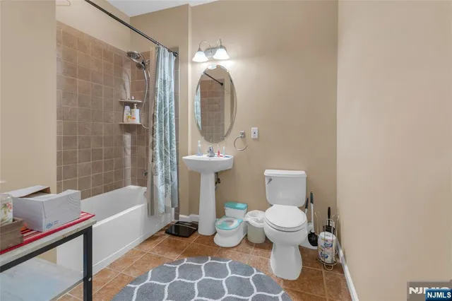 a bathroom with a toilet a sink and bathtub
