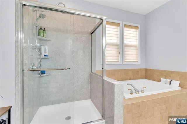 a bathroom with a tub and a shower