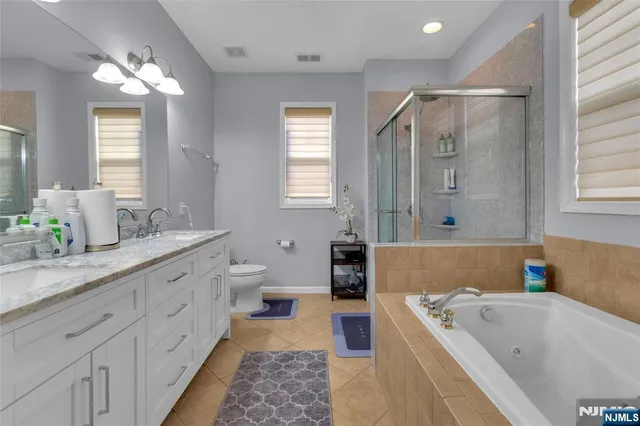 a bathroom with a tub sink and mirror