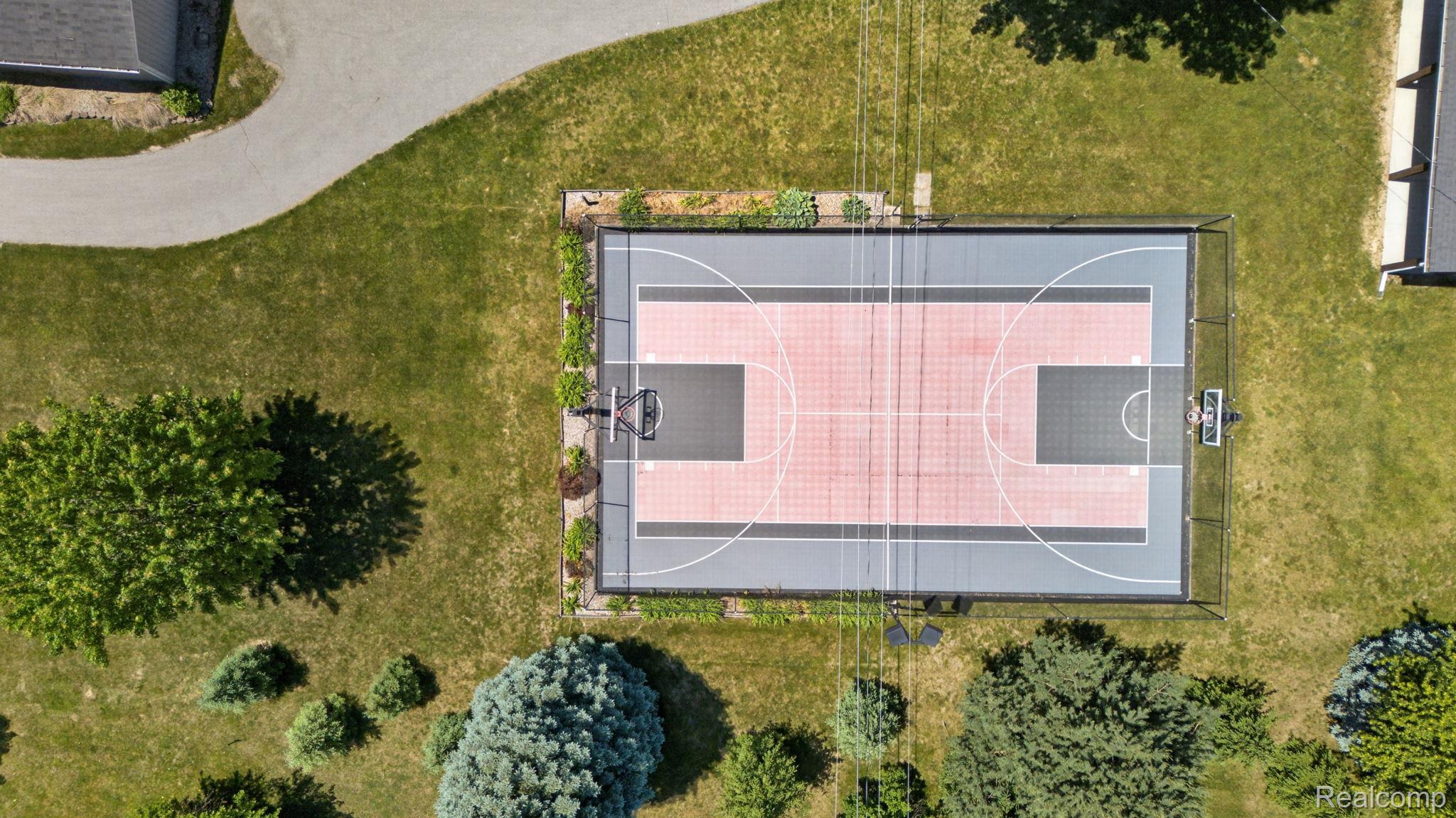 9353 Hill Road Swartz Creek, MI 48473 - Photo 92 of 98 Fenced multi-sport court featuring a grey and red playing surface with white line markings