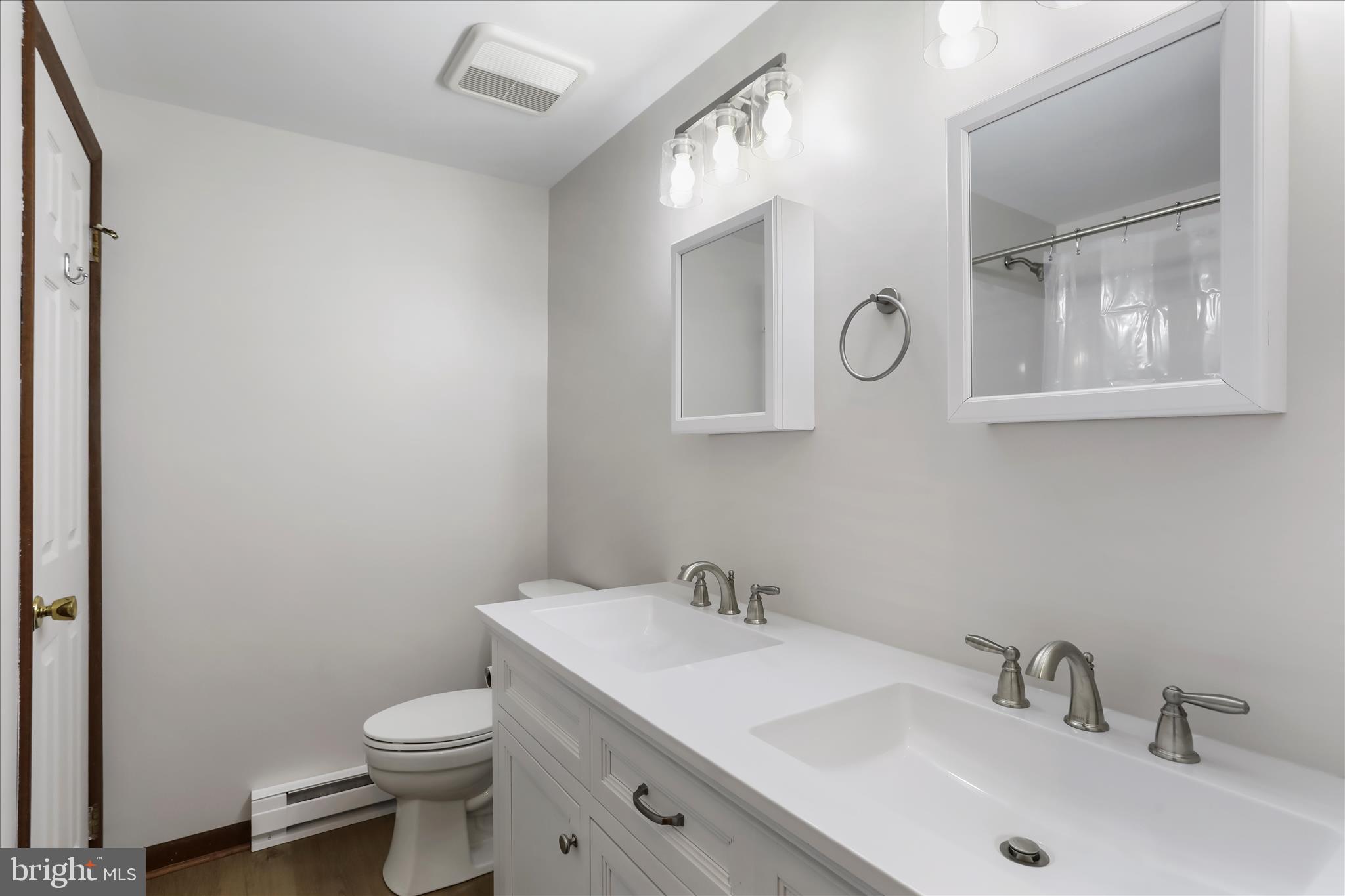 24744 Raven Rock Road Smithsburg, MD 21783 - Photo 21 of 49 a bathroom with a toilet a sink and mirror