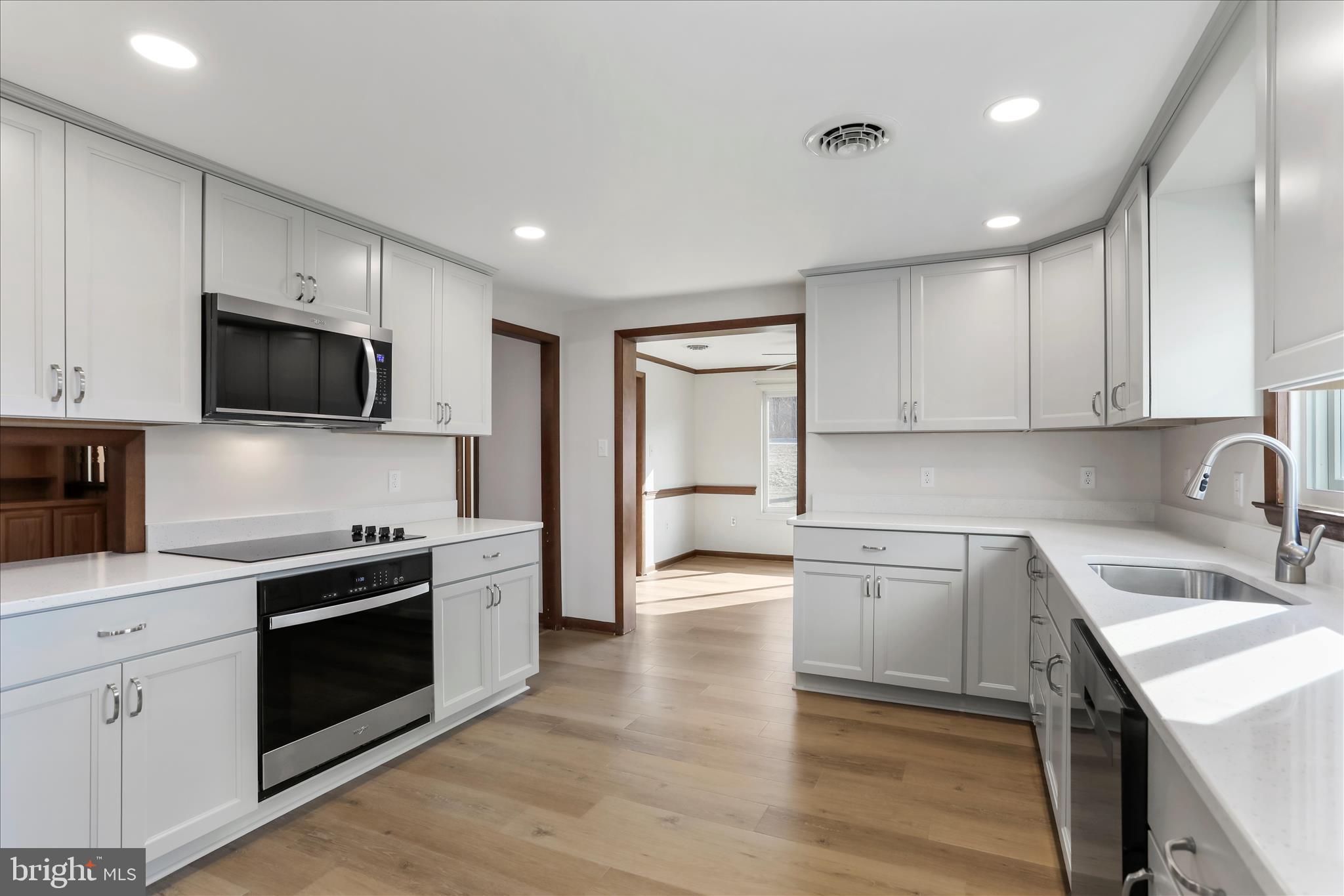 24744 Raven Rock Road Smithsburg, MD 21783 - Photo 5 of 49 a kitchen with a sink a stove top oven and cabinets
