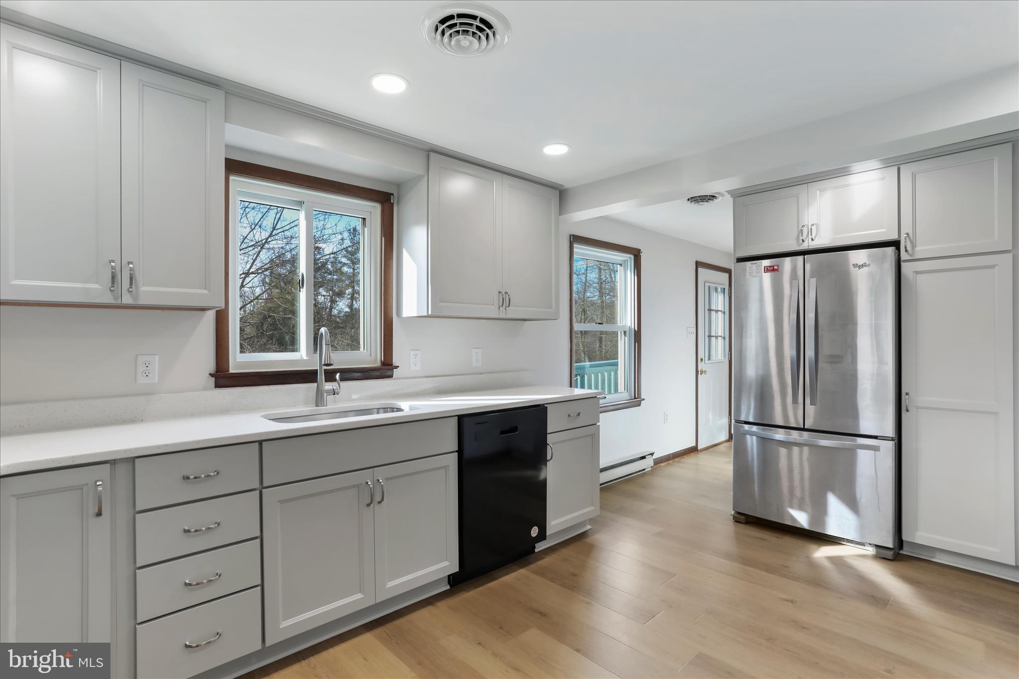 24744 Raven Rock Road Smithsburg, MD 21783 - Photo 7 of 49 a kitchen with a refrigerator and white cabinets