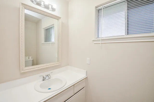 a bathroom with a sink and a mirror