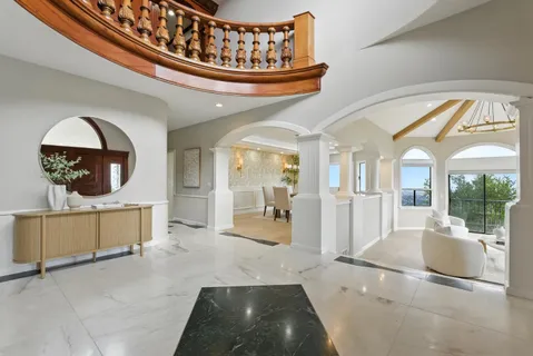 a large kitchen with kitchen island granite countertop a stove top oven a sink a dining table and chairs