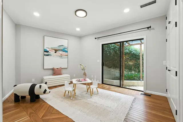 a view of a house with wooden deck and furniture