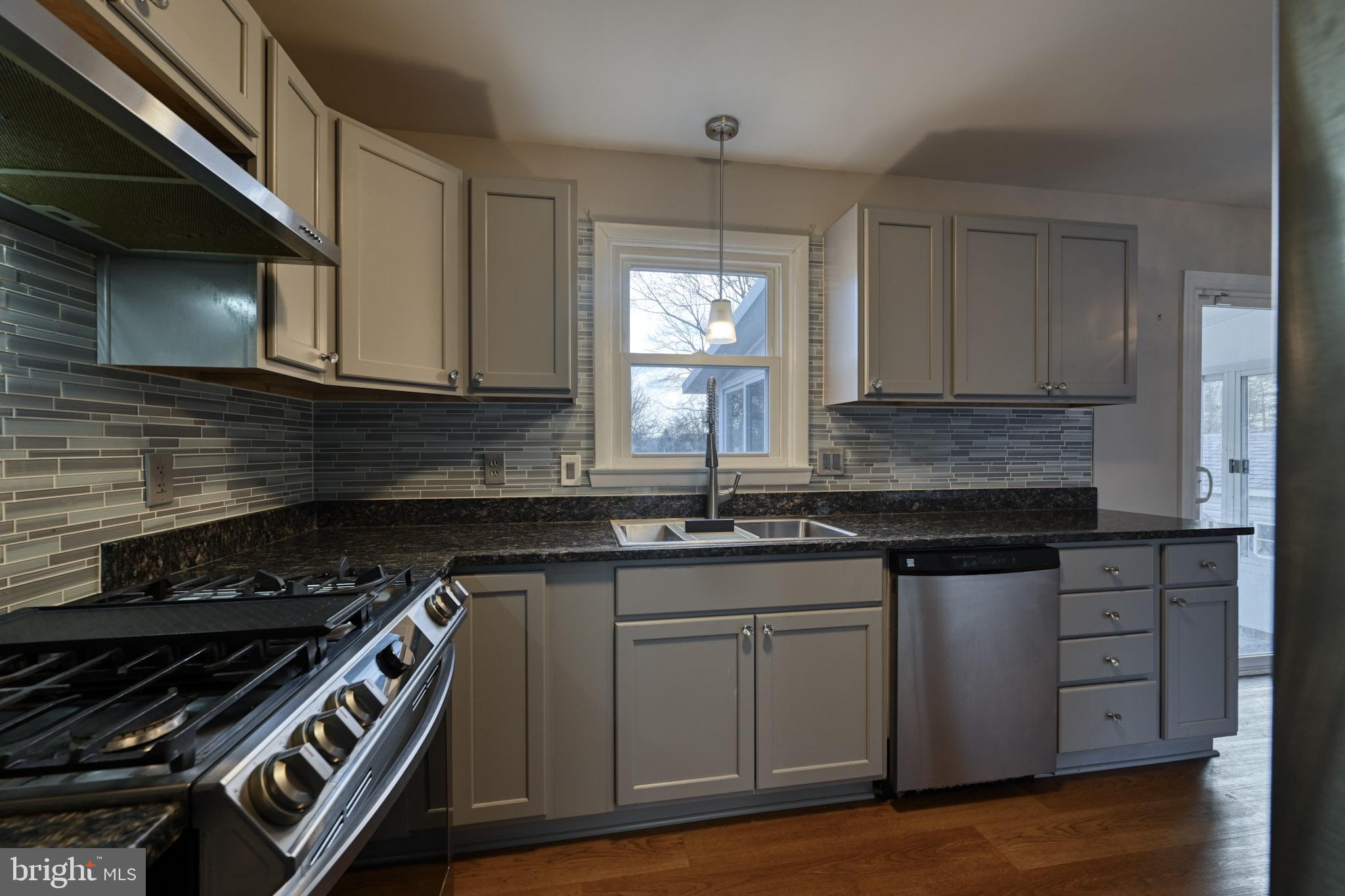 3500 East Lawndale Road Reisterstown, MD 21136 - Photo 13 of 31 a kitchen with granite countertop a stove sink and cabinets