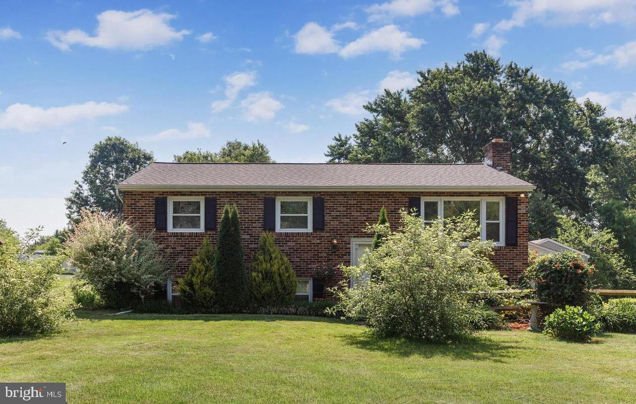 3500 East Lawndale Road Reisterstown, MD 21136 - Photo 2 of 31 a front view of house with yard and trees in the background
