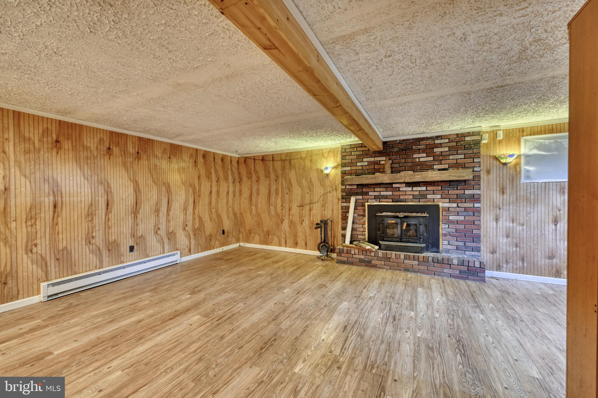 3500 East Lawndale Road Reisterstown, MD 21136 - Photo 21 of 31 a view of an empty room with wooden floor fireplace and a window