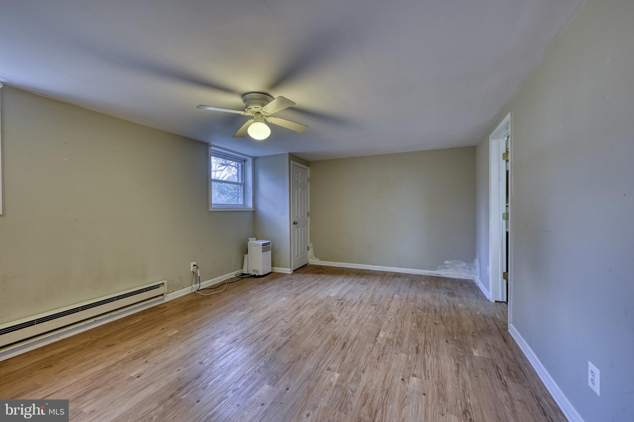 3500 East Lawndale Road Reisterstown, MD 21136 - Photo 25 of 31 an empty room with wooden floor fan and windows