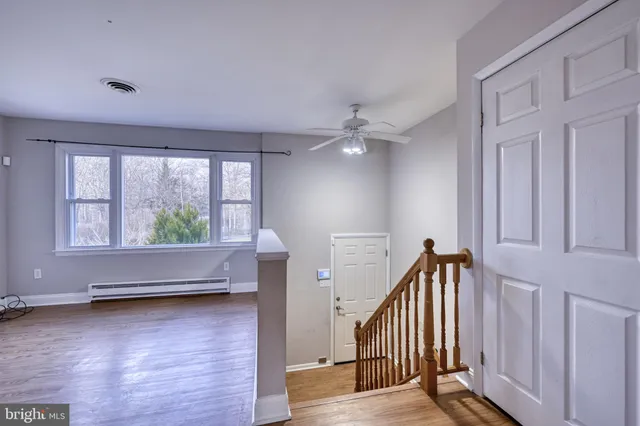 a view of an entryway with wooden floor
