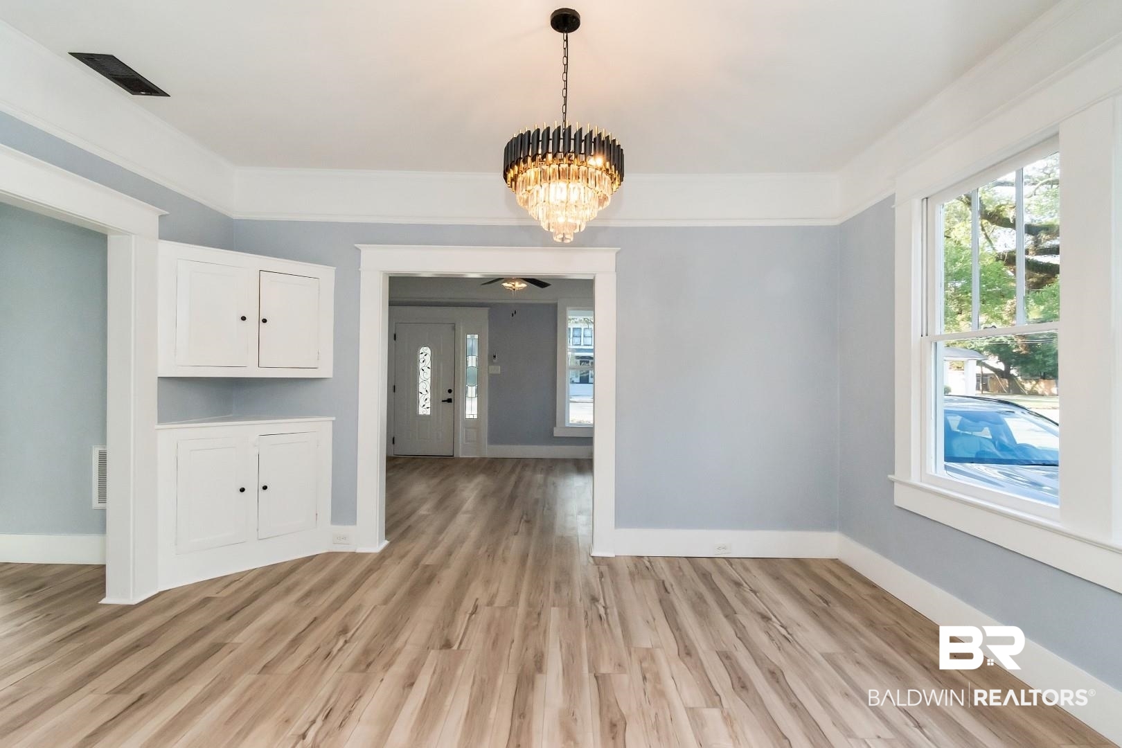 555 Michigan Avenue Mobile, AL 36604 - Photo 4 of 28 Unfurnished dining area featuring light wood-type flooring and ceiling fan with notable chandelier