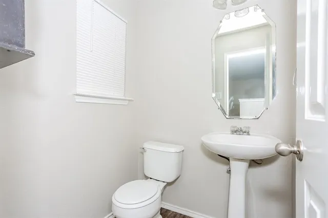 a bathroom with a sink mirror toilet and a mirror