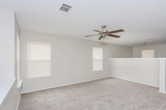 a view of a livingroom with a ceiling fan and window