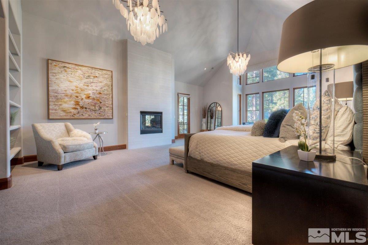 6090 Lake Geneva Drive Reno, NV 89511 - Photo 14 of 40 a bedroom with a bed and a chandelier