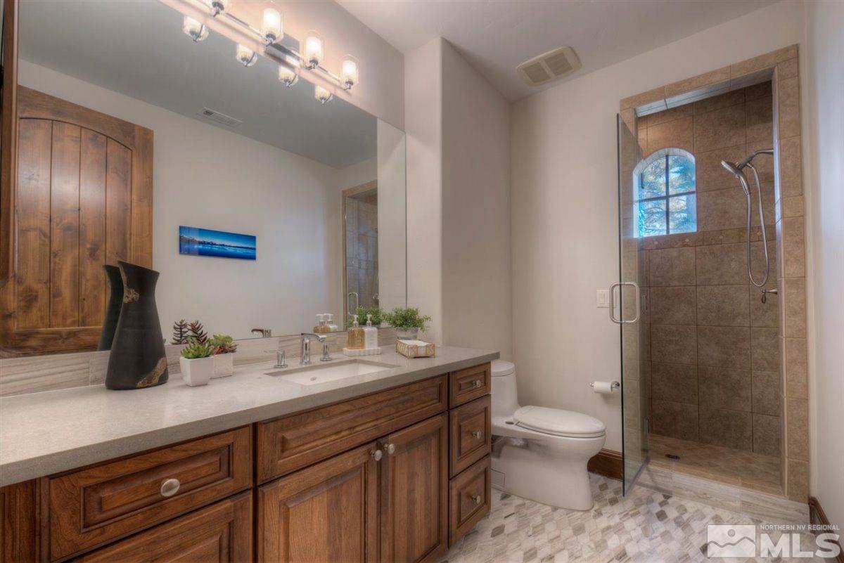 6090 Lake Geneva Drive Reno, NV 89511 - Photo 21 of 40 a bathroom with a toilet sink and mirror