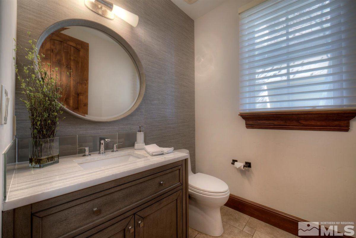 6090 Lake Geneva Drive Reno, NV 89511 - Photo 31 of 40 a bathroom with a toilet a sink and mirror