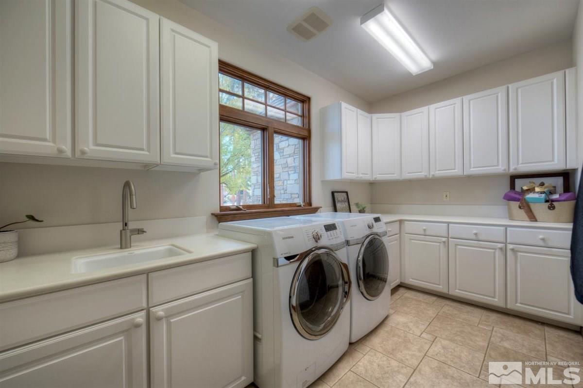 6090 Lake Geneva Drive Reno, NV 89511 - Photo 32 of 40 a utility room with cabinets washer and dryer