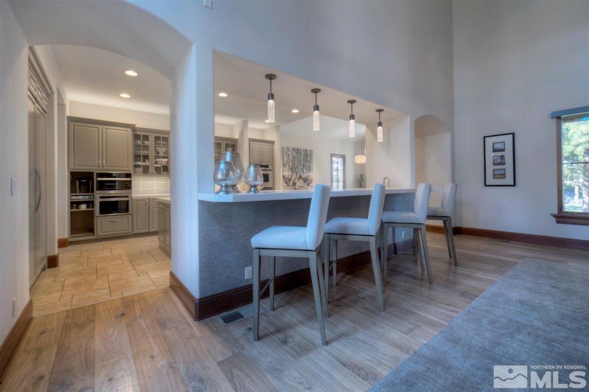 6090 Lake Geneva Drive Reno, NV 89511 - Photo 8 of 40 a view of a dining room with furniture and wooden floor