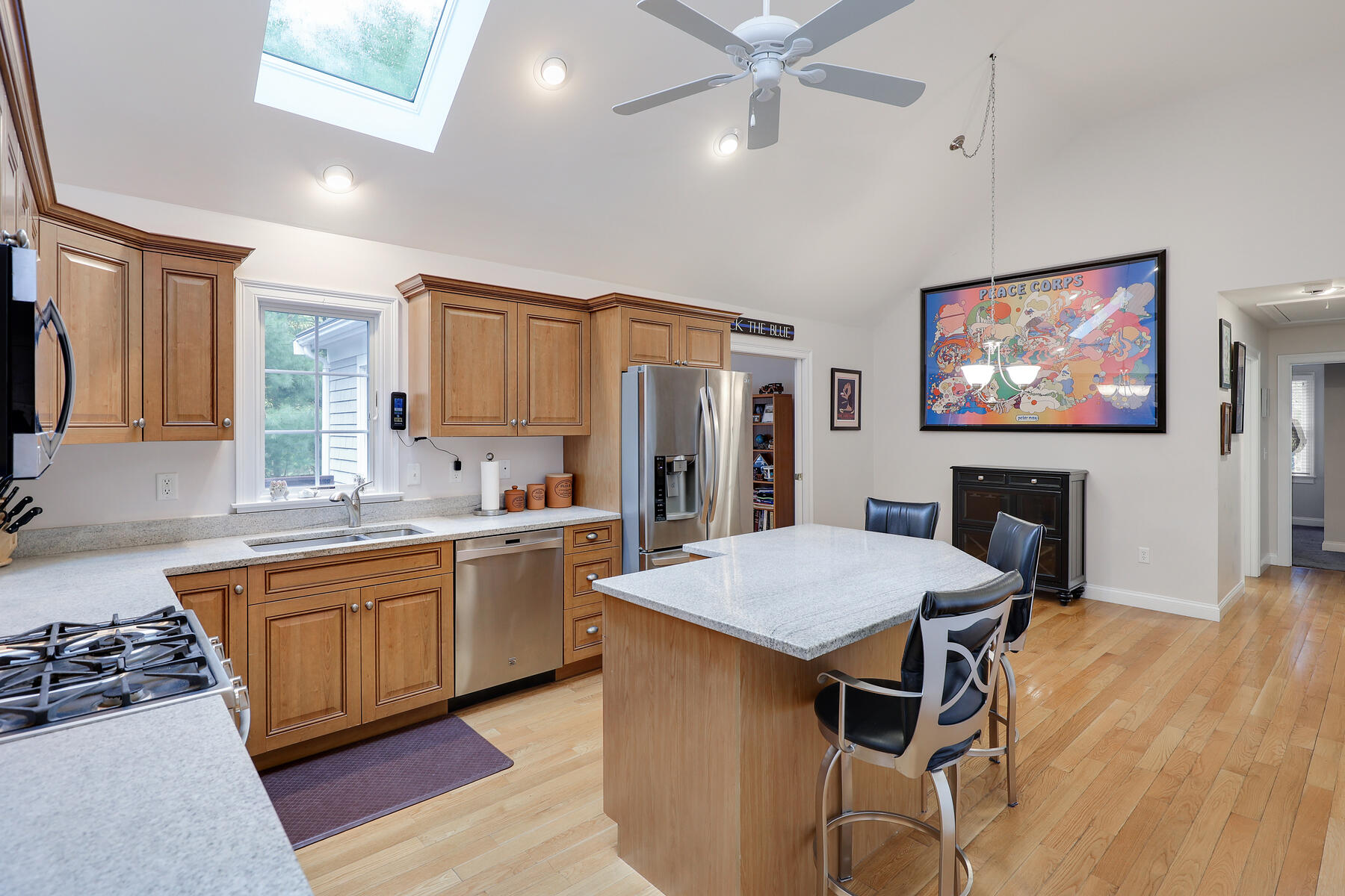 24 Sea Robin Road Osterville, MA 02655 - Photo 9 of 45 a open kitchen with stainless steel appliances granite countertop a stove top oven a sink a dining table and chairs with wooden floor