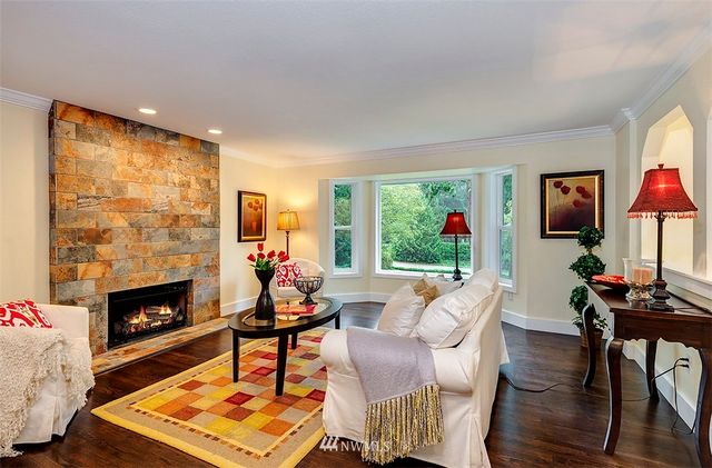 a living room with furniture fireplace and flat screen tv