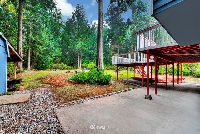 a view of a patio with a table and chairs under an umbrella