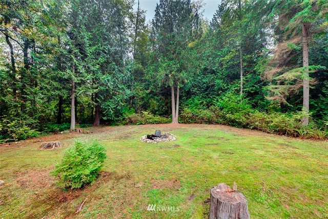 a backyard of a house with a yard and seating space
