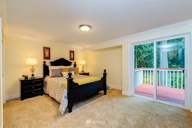 a bedroom with bed and a large window