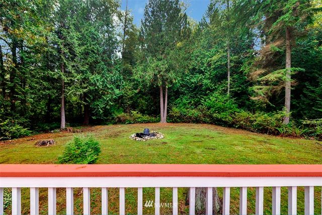 a view of small yard with white fence