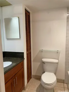 a bathroom with a toilet a sink and mirror