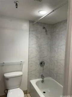 a bathroom with a toilet and a washing machine