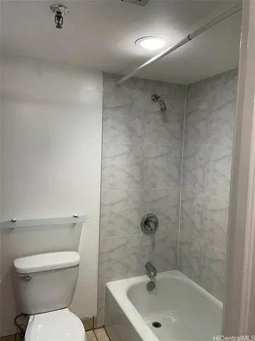 a bathroom with a toilet and a washing machine