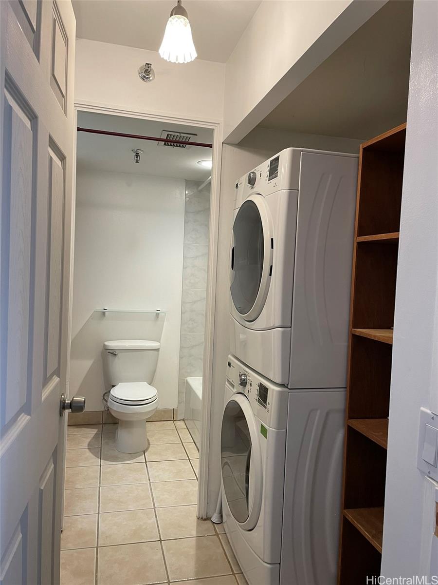 2040 Nuuanu Avenue, Unit 1203 Honolulu, HI 96817 - Photo 7 of 16 a bathroom with a toilet and a washing machine