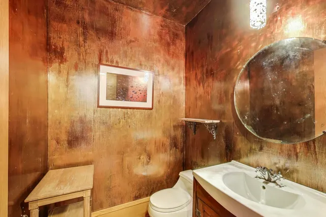 a bathroom with a sink toilet and mirror