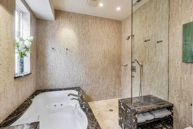 a bathroom with a tub and a sink