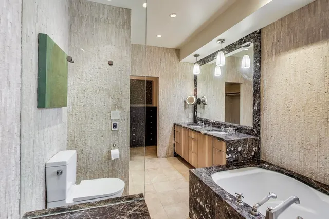 a bathroom with a granite countertop sink mirror bathtub and shower