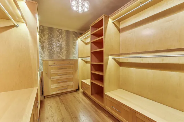 a view of walk in closet with empty racks