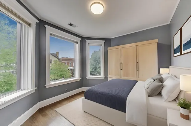 a bedroom with a large bed and a large window